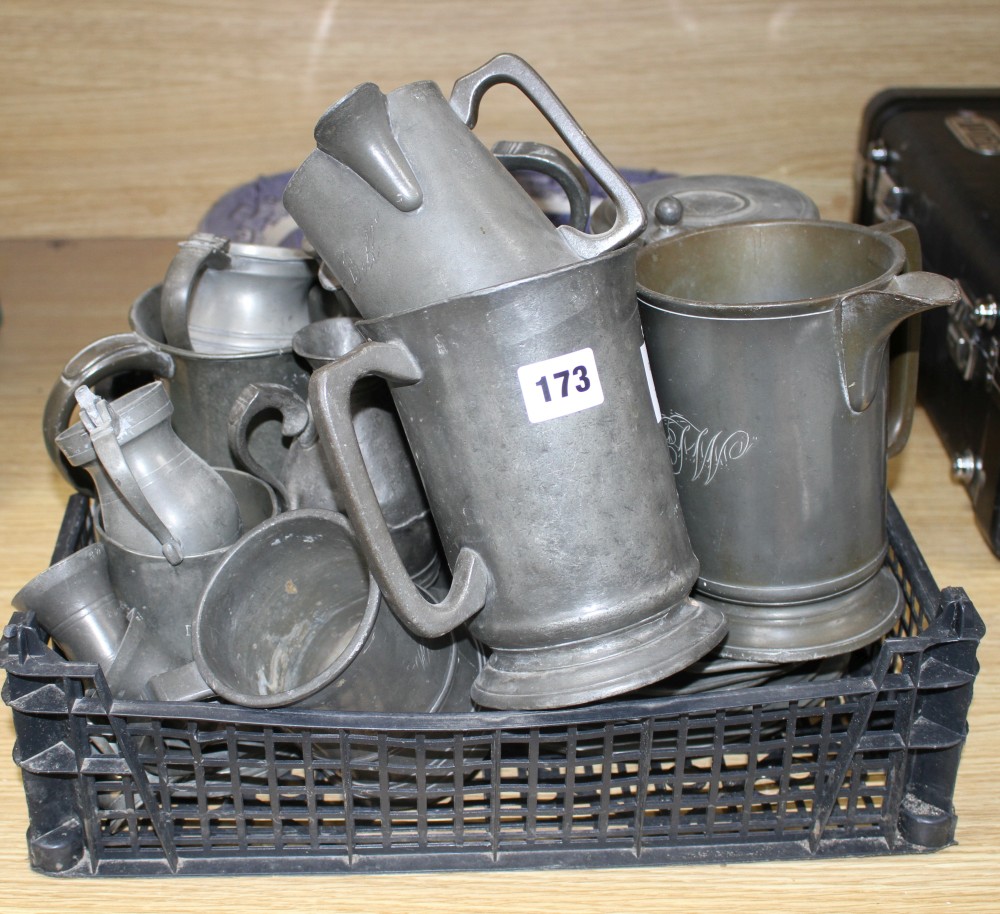 A collection of assorted pewter mugs, measures and dishes